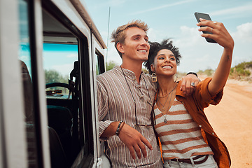 Image showing Couple, phone selfie and safari travel on game drive in nature environment, sand desert or dry Kenya landscape. Smile, happy and bonding interracial man and woman with 5g mobile technology photograph