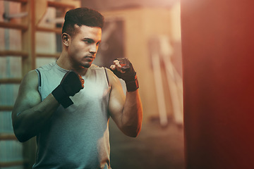 Image showing Boxer, workout or training man with punching bag working on sports fitness, exercise and strength. Athlete, fighter or martial arts in a boxing, health and wellness gym or fight club studio