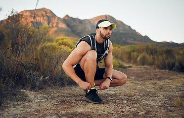 Image showing Exercise, fitness on mountains and runner man with outdoor workout, wellness and healthy lifestyle with motivation or goal. Young person training on hiking dirt road in the morning with sports shoes