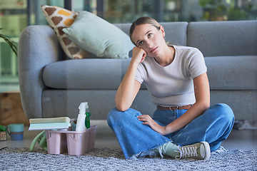 Image showing Woman, tired and stress for cleaning house sitting on floor with exhausted look on face. Girl, working and burnout in home living room with headache with soap, spray and brush for domestic work