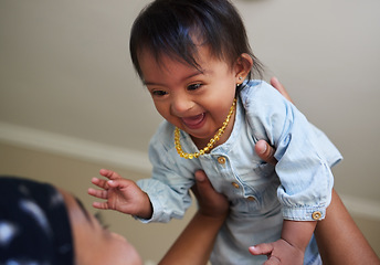 Image showing Children, down syndrome and fun with a girl and mother playing together in their home. Family, kids and disability with an adorable or cute daughter laughing with her parent while being playful