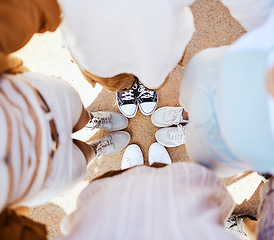 Image showing Friends, group and circle with shoes together for happiness, solidarity and bonding on holiday. People, sneakers and happy together with feet on sand in fun huddle on travel, vacation or road trip