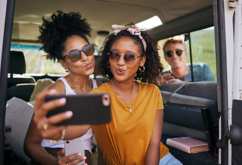 Image showing Selfie, phone and road trip with girl friends taking a photograph while sitting in a car or van on vacation. Mobile, social media and transportation with a female and friend posing for a picture