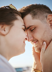 Image showing Love, touching face and couple on the beach, woman holding man with heads together. Summer, romance and loving happy couple on holiday. Real people, vacation and people in love bonding and affection