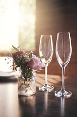 Image showing Champagne, luxury toast and glass for alcohol wine drink in party, birthday celebration or anniversary success. Texture, pink roses and cocktail glasses with house kitchen, home or restaurant flowers