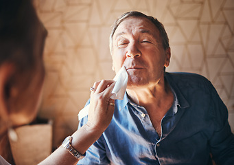 Image showing Man, lunch and woman wipe mouth in retirement while together in home for breakfast, dinner or food. Elderly, couple and care with lady cleaning husband face during meal in house, cafe or restaurant