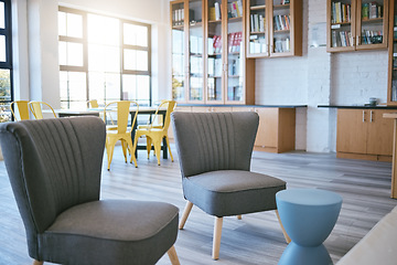 Image showing Library, bookstore and furniture with interior decorating, wood floor and sunshine. College, university or school reading lounge, room or space to relax with books for education, learning and study