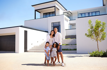 Image showing Portrait, real estate and happy family moving into their new luxury home, house or property in summer. Happy parents and children standing with a smile outdoor with building investment or purchase