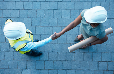Image showing Architect partnership, client handshake and construction worker meeting at building site, property deal or engineering trust. Above industrial contractor shaking hands, agreement or design consulting