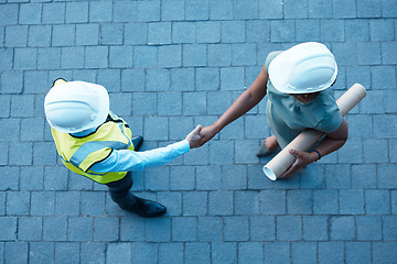 Image showing People handshake on site, architect partnership with engineer in construction and welcome b2b in Atlanta. Industrial designer with blueprint, contractor collaboration and project teamwork top view