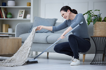 Image showing Woman, cleaning home and with broom sweeping carpet for daily chores, cleanliness and doing housework. Cleaner, domestic and lady complete duties, clean under mat for dust, health and hygiene