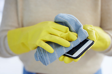 Image showing Hands, gloves and cleaning phone screen of germs, bacteria with alcohol wipe or dust cloth. Covid, disinfection and safety, clean smartphone in home or office for protection from virus infection.