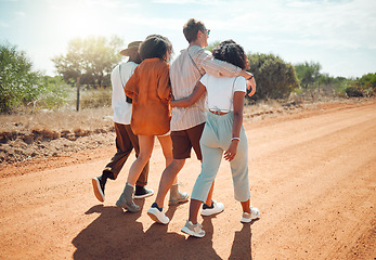 Image showing Friends, hug and travel in the countryside for summer vacation walking together on a desert road in nature. People in friendship support, care and love hugging in the safari for holiday walk or trip