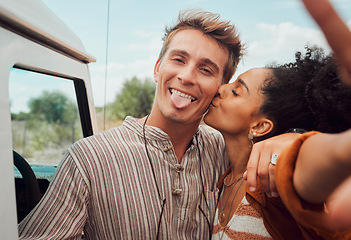 Image showing Selfie, kiss and couple taking a picture on a road trip, having fun on a traveling adventure together. Love, nature and black woman kissing man for photo, bond in romantic moment in the countryside