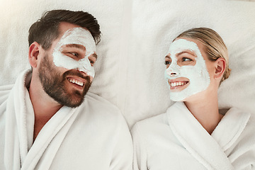 Image showing Love, face mask and skincare couple relax, body care and in gowns on spa vacation celebrate anniversary, honeymoon or relationship. Man and woman on holiday smile together, on retreat and bonding.