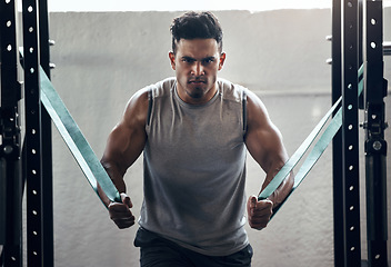 Image showing Man, resistance band and bodybuilding in gym workout, training and exercise with health, wellness and strong muscle motivation. Portrait, personal trainer or bodybuilder in fitness with power mindset