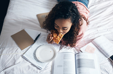 Image showing Bed, girl and student studying with pizza for lunch in her bedroom reading school for tests or exams at home. Female enjoys fast food and learning from a notebook and university or college textbooks