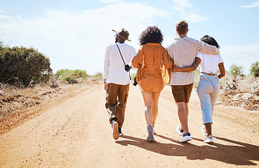 Image showing Friends, walking and travel with young people in nature on a sand road with a beautiful desert view of the sky. Vacation, summer and walk with a man and woman group outdoor for a trip or holiday