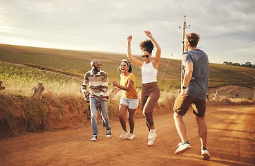 Image showing Friends, nature and dance with a man and woman group outdoor in a desert on a sand road with freedom. Travel, summer or vacation with young people enjoying a holiday together and laughing or joking