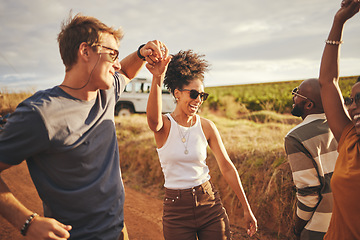 Image showing Friends, road trip and dance with a man and woman on a vacation, holiday or getaway in the dessert on a sand road. Travel, diversity and nature with a group of young people enjoying freedom outside