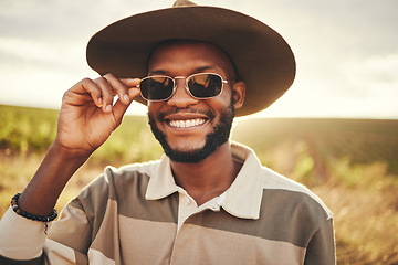 Image showing Black man, sunglasses and farm fashion, holiday vacation and travel with fresh look, cool and relax on road trip. Young male, wear hat and happy smile, adventure and getaway during summer break.