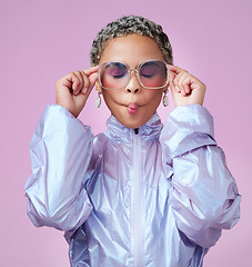 Image showing Fashion, beauty and lips with a black woman or model in sunglasses pouting in studio on a pink background. Trendy, style and edgy with an attractive, goofy female posing in contemporary clothes