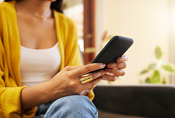 Image showing Sofa, home and hands typing with phone chat, social media or networking connection on mobile app, internet or house wifi. Woman with cellphone technology texting message or communication in lounge