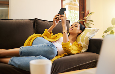 Image showing Relax woman on her phone with social media while on the sofa in house. Content female browsing internet with app while relaxing on the couch at home reading news, post and internet or web