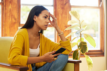 Image showing Stress, tired and woman with headache on phone sitting on chair in the living room of her home. Bad news, burnout and frustrated girl from Colombia scrolling on social media with smartphone in lounge