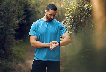 Image showing Smartwatch, fitness and forest man check workout results or digital training progress for outdoor wellness lifestyle. Sports or athlete runner person with a smart watch for exercise motivation goals