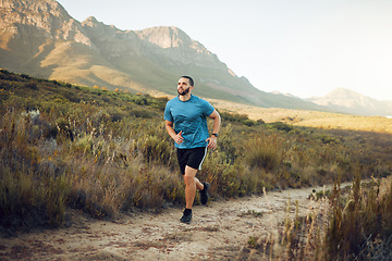 Image showing Health, mountain and man running in nature for fitness, training and sports exercise. Workout, wellness and summer with athlete runner in grass field path for peace, marathon and outdoor morning jog