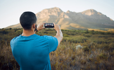 Image showing Smartphone photography, mountain and hiking man in nature for outdoor adventure, social media location update or gallery memory. Young influencer taking landscape picture with cellphone for trekking