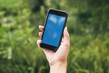 Image showing Nature, hand of woman with phone and mockup or green screen, contact us outside. Outdoor plants, leaves in background and smartphone in hands with 5g wifi internet connection and business information