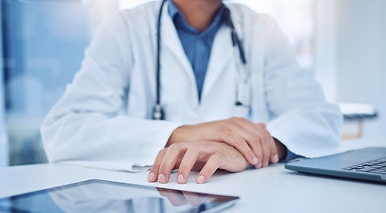 Image showing Hands, tablet and healthcare with a doctor at a desk in the hospital for medicine, insurance or consulting. Trust, medical and internet with a male surgeon sitting in a clinic for health or wellness