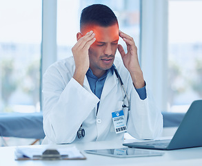 Image showing Doctor, headache and hospital with burnout, laptop and technology tired at workplace. Medic, hands and head with pain, frustrated and stress working in clinic, medical or healthcare facility in Miami