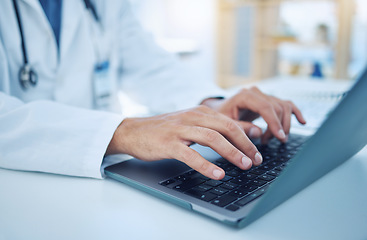 Image showing Hands, laptop and healthcare with a doctor typing for research, doing a search on the internet in a hospital. Computer, medical and analytics with a male medicine professional at work in a clinic