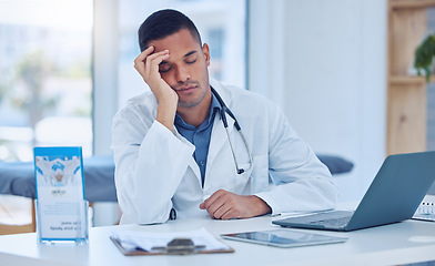 Image showing Tired man in medical hospital, doctor napping at office desk and healthcare burnout in India. Exhausted stress nap from insomnia, sleeping male by laptop desk and mental health in doctors clinic