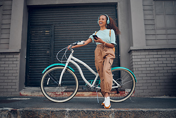 Image showing Bicycle, phone and happy woman with headphones for music while on walk in the city street. Happiness, smile and girl from Puerto Rico listening to audio, podcast or radio on smartphone in urban road.