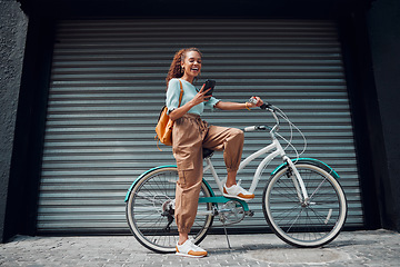 Image showing Bicycle, woman and phone in city feeling excited and happy about message while outdoor in summer with trendy look. Eco friendly transportation for carbon footprint female on a bike using 5g network