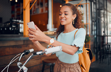 Image showing Bicycle, smartphone and black woman in city using phone for social media, carbon footprint and outdoor online communication. Student, travel bike and 5g cellphone internet search for urban wellness
