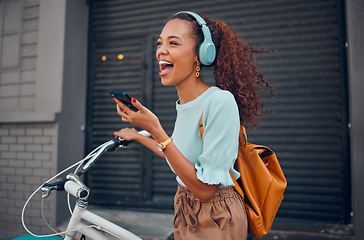 Image showing Woman, happy and bicycle with music on phone while on ride in city. Black woman, excited and smile with smartphone for communication, call or streaming on app with bike to reduce carbon footprint