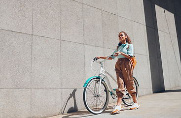 Image showing Bike, urban and city woman on a bicycle ride walking to cut carbon footprint for sustainability. Person relax after riding on a summer day feeling calm and relax with eco friendly transportation