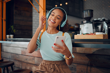 Image showing Phone, music and coffee shop with a woman customer streaming audio on headphones in her local internet cafe. Mobile, radio and 5g with a young female using a subscription service in a restaurant