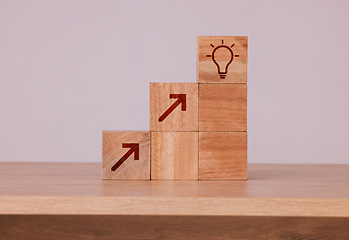 Image showing Wood, blocks and idea with light bulb icon for creativity, innovation and development with wooden cubes against studio background. Brainstorming, conclusion and motivation for growth, action or goal