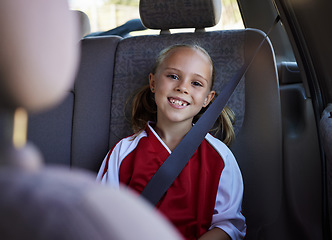 Image showing Soccer, travel and girl in a car with a happy, excited and big smile for a sports training match exercise for kids. Road, safety and young child traveling in a vehicle to a weekend football trip