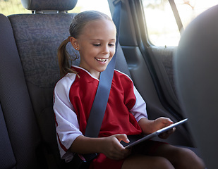 Image showing Happy, girl child and with tablet in car smile, browse online and use social media apps while buckled up. Female kid, use digital device or after practice, share winning soccer match or playing game