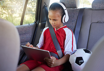 Image showing Tablet, sports and relax child on car travel transportation to soccer, football or match game in SUV van with safety seat belt. Youth girl streaming video, subscription movie or use kid friendly app