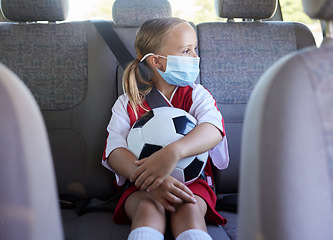 Image showing Covid, soccer and girl in a car to travel in backseat to a youth football training game for exercise and training. Face mask, coronavirus and young child in traffic traveling to a kids sports match