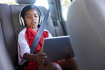 Image showing Sports, car travel and relax child with tablet on journey to soccer practice while streaming video, watch movie or play online games. Transport, SUV van or kid girl using tech before football match