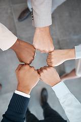 Image showing Fist, meeting and employees in a circle for support, team building and partnership in an office at work. Top view of hands of corporate workers for motivation, success and solidarity working together
